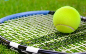 tennis ball sit on a tennis racquet
