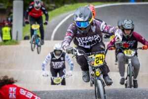 BMX riders race around a track