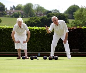 two people play lawn bowls